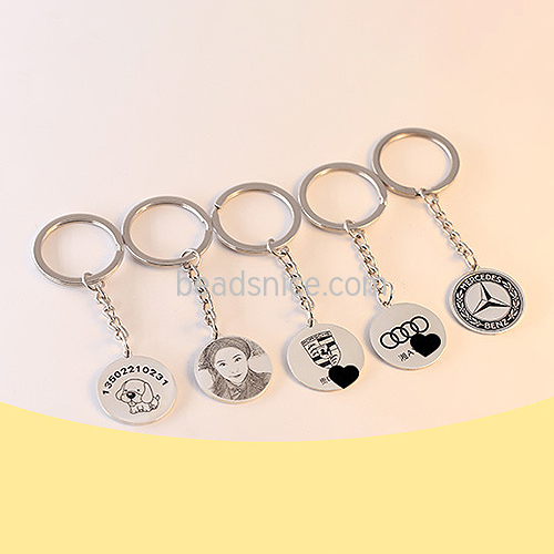 A single 1” sterling silver disc is stamped on a spiral and attached to a 25 mm 925 silver key ring.